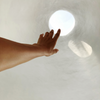 Hand reaching out to touch light