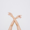 Woman's raised crossed arms