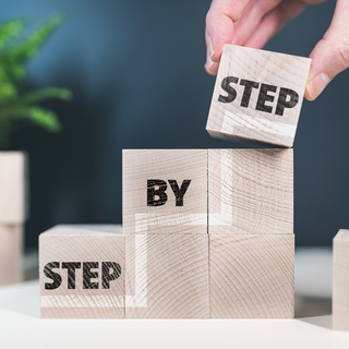 Step by Step on Small Wooden Cubes