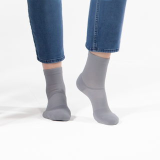 Womans feet and lower legs showcased in Apolla crew compression socks featuring targeted support and moisture-wicking technology for enhanced comfort and performance