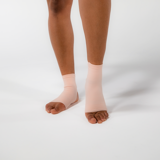 A womans feet in Apolla ankle compression socks, designed to improve circulation and reduce swelling for all-day comfort.
